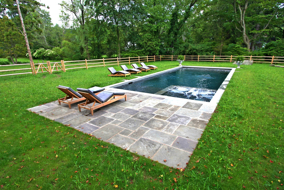 Country backyard rectangular lap pool in New York.