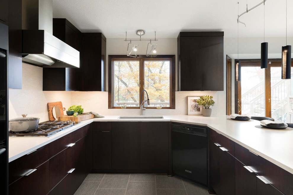 Mid-sized contemporary u-shaped eat-in kitchen in Minneapolis with an undermount sink, flat-panel cabinets, dark wood cabinets, quartz benchtops, grey splashback, black appliances, vinyl floors, a peninsula, grey floor and grey benchtop.