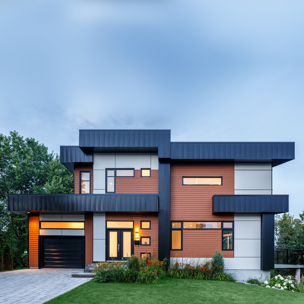 Photo of a contemporary two-storey exterior in Chicago with mixed siding and a flat roof.