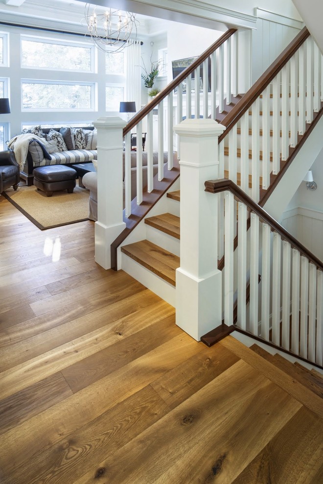 This is an example of a transitional wood staircase in Calgary with painted wood risers.