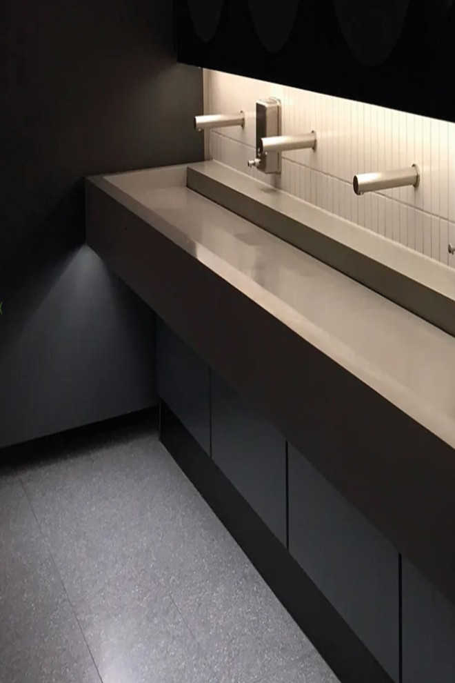 Inspiration for a small ensuite bathroom in Los Angeles with flat-panel cabinets, black cabinets, black tiles, ceramic tiles, black walls, a wall-mounted sink, solid surface worktops, grey floors, black worktops, a single sink and a floating vanity unit.