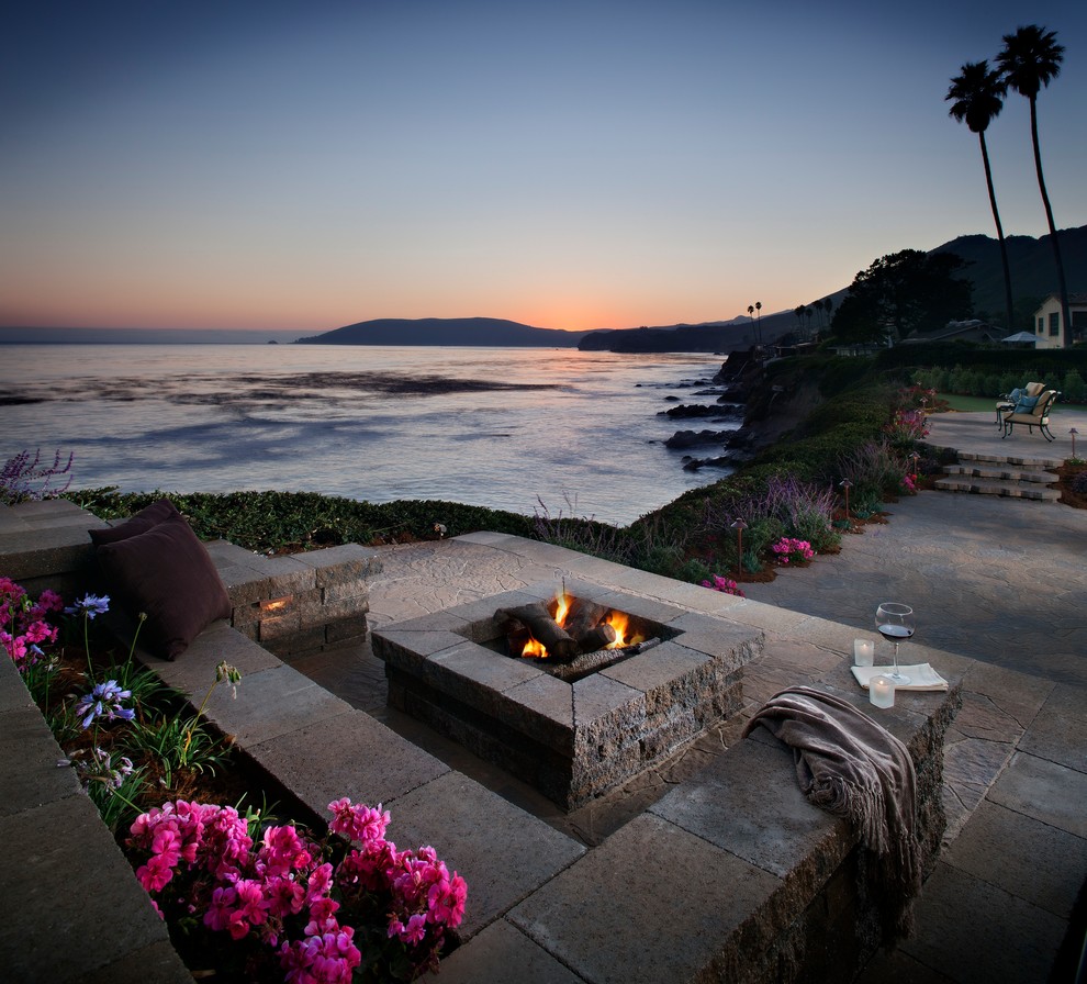 Inspiration for a beach style backyard patio in New York with a fire feature, natural stone pavers and no cover.