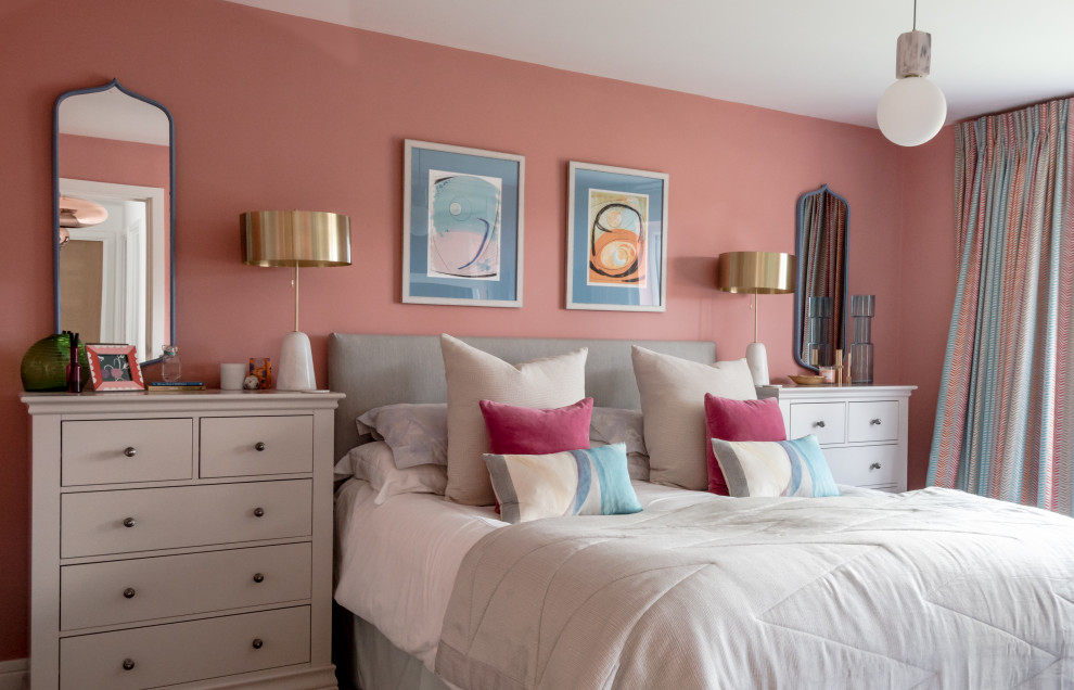 Design ideas for a mid-sized modern master bedroom in West Midlands with pink walls, carpet, no fireplace, a concrete fireplace surround and grey floor.