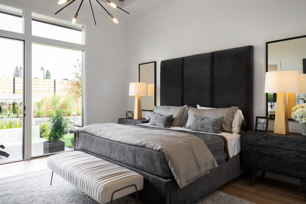 Inspiration for a large contemporary master bedroom in Portland with white walls, medium hardwood floors and no fireplace.