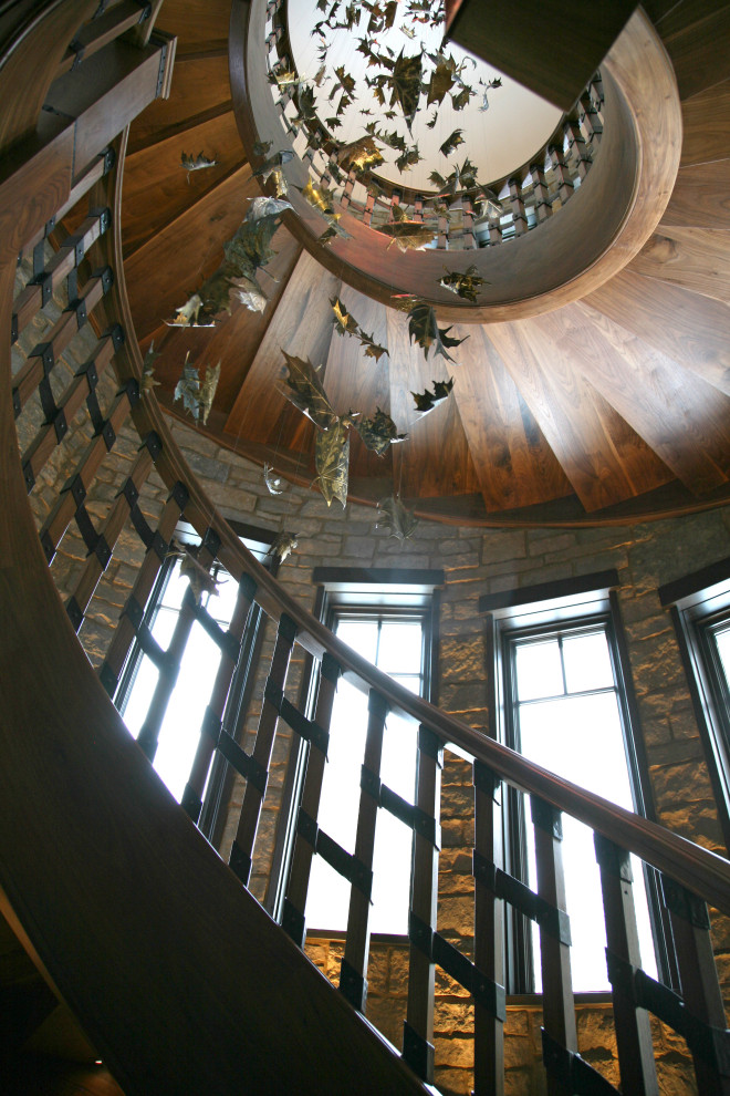 Inspiration for a large country wood curved staircase in Milwaukee with wood risers, mixed railing and brick walls.
