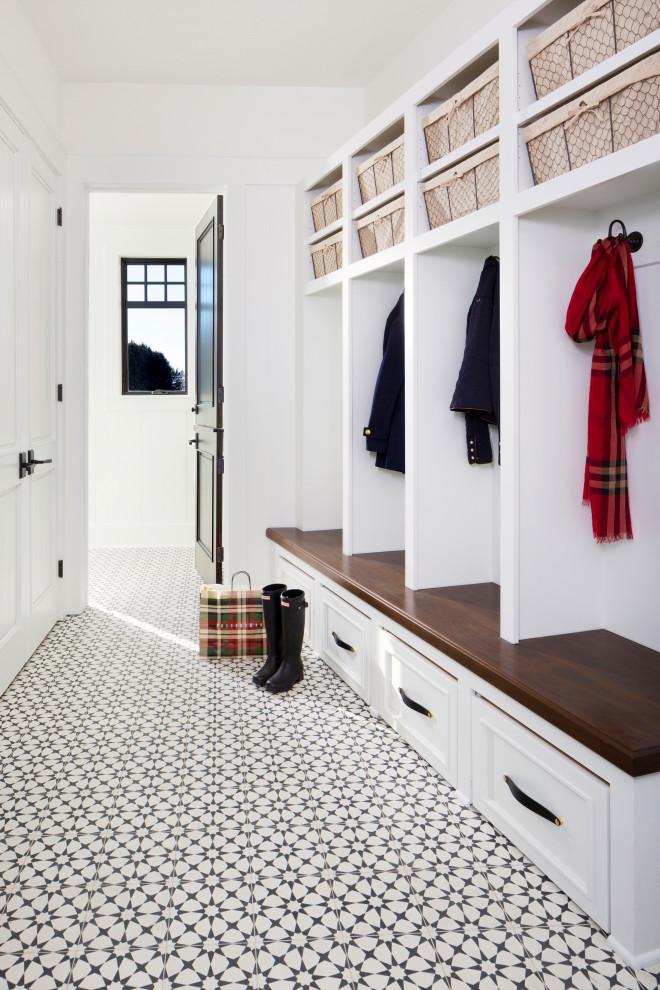 Inspiration for a large transitional mudroom in Milwaukee with white walls, a single front door, ceramic floors and multi-coloured floor.