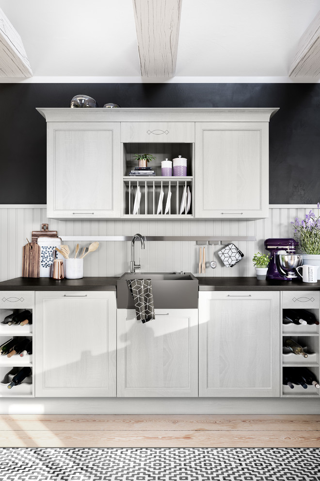 Inspiration for a mid-sized traditional l-shaped eat-in kitchen in Calgary with a farmhouse sink, shaker cabinets, white cabinets, granite benchtops, white splashback, timber splashback, stainless steel appliances, light hardwood floors, no island, beige floor and black benchtop.