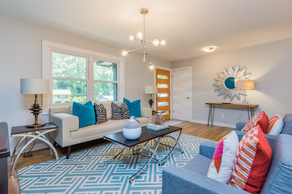 Midcentury living room in Atlanta with beige walls and brown floor.
