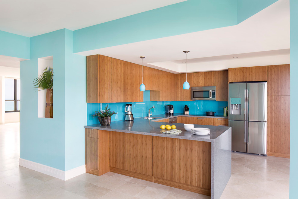 Mid-sized contemporary u-shaped eat-in kitchen in Miami with an undermount sink, flat-panel cabinets, medium wood cabinets, quartz benchtops, blue splashback, glass sheet splashback, stainless steel appliances, marble floors and with island.