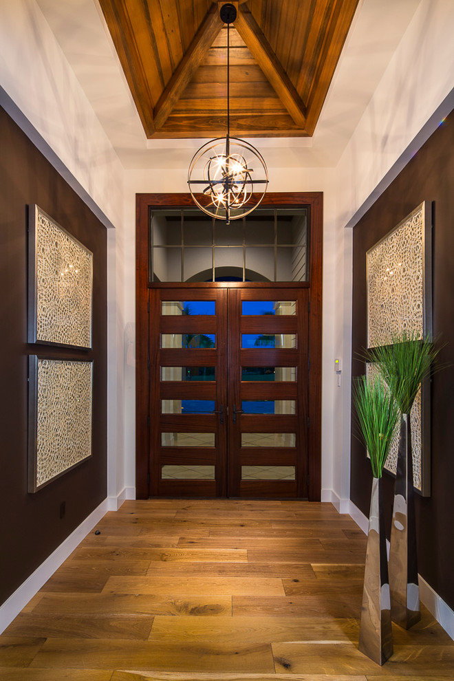 Large transitional entryway in Tampa with white walls, medium hardwood floors, a double front door and a dark wood front door.