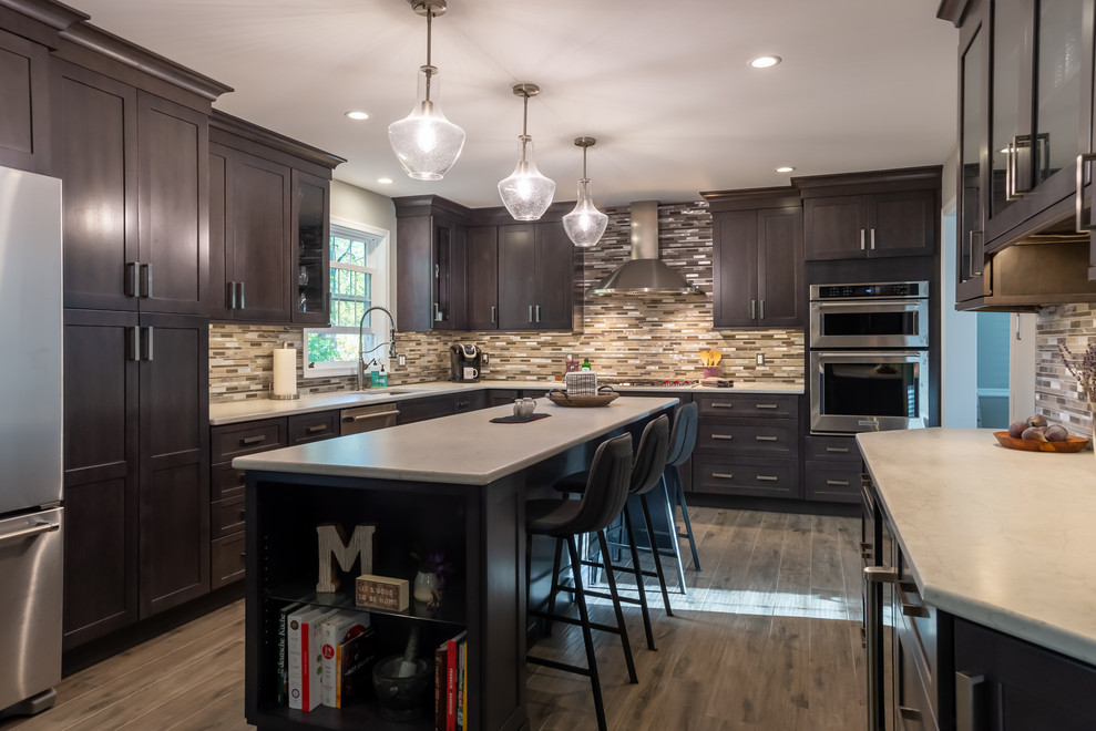 Example of a mid-sized transitional l-shaped porcelain tile and brown floor eat-in kitchen design in Philadelphia with an undermount sink, shaker cabinets, dark wood cabinets, quartz countertops, multicolored backsplash, porcelain backsplash, stainless steel appliances, an island and gray countertops