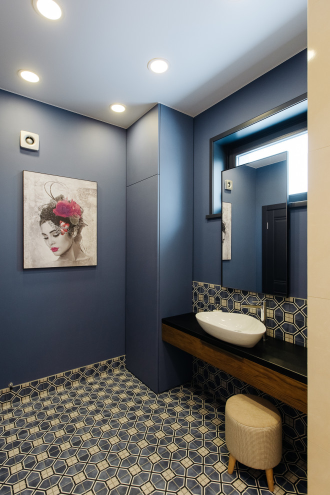 Пример оригинального дизайна: маленькая ванная комната в современном стиле с разноцветной плиткой, керамогранитной плиткой, полом из керамогранита, накладной раковиной, синим полом, черной столешницей, окном, тумбой под одну раковину и подвесной тумбой для на участке и в саду