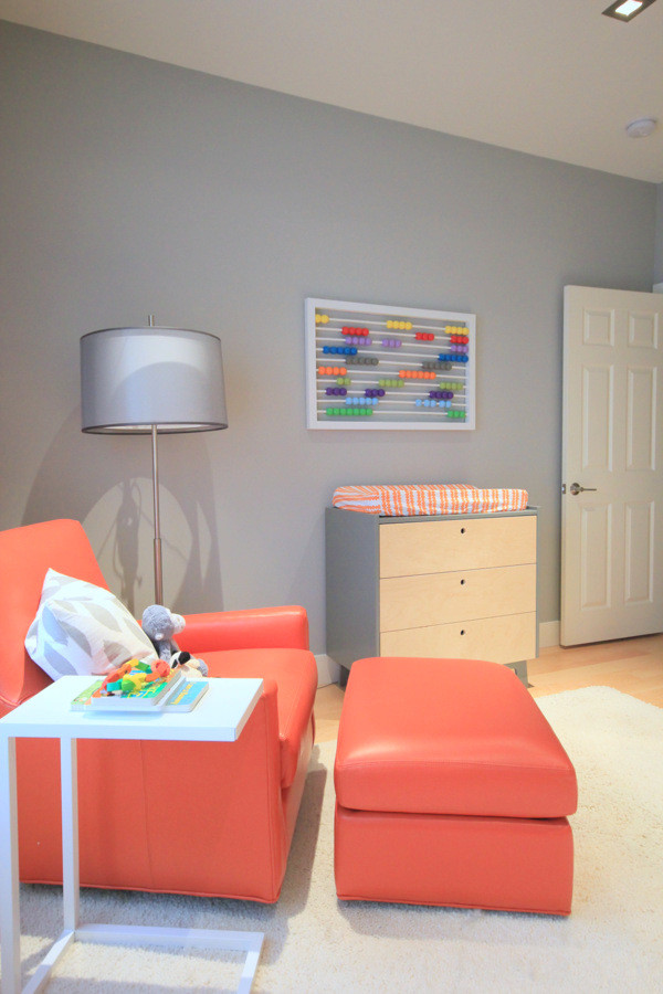 This is an example of a mid-sized contemporary gender-neutral nursery in Los Angeles with grey walls and light hardwood floors.