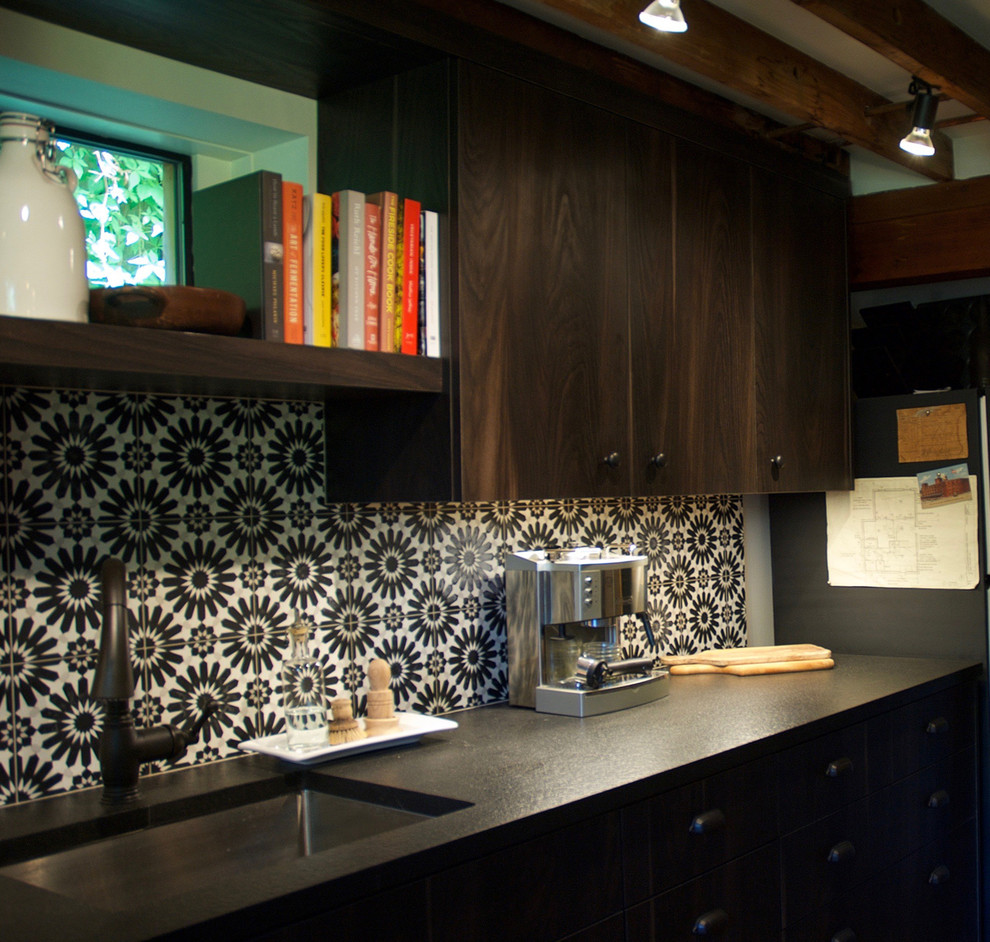Kitchen - mid-sized transitional single-wall concrete floor kitchen idea in Seattle with an undermount sink, flat-panel cabinets, dark wood cabinets, granite countertops, white backsplash, cement tile backsplash, paneled appliances and no island