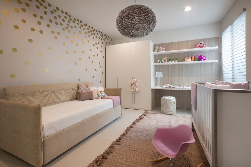 Contemporary nursery in Miami with grey walls for girls.
