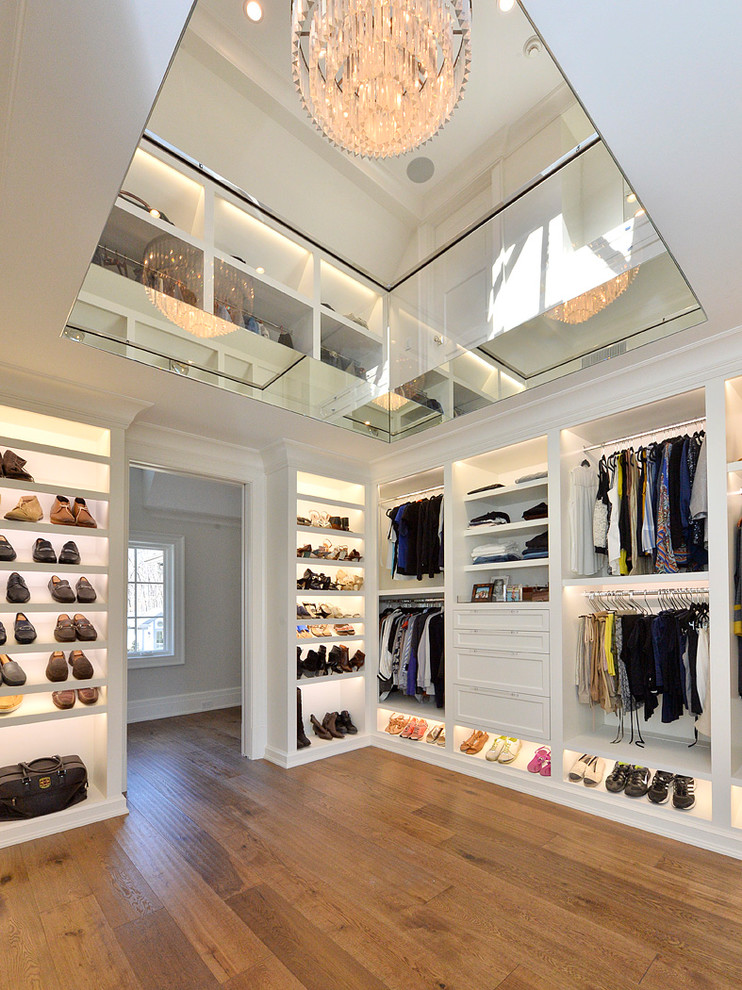 Inspiration for a contemporary gender-neutral walk-in wardrobe in Other with shaker cabinets, white cabinets, medium hardwood floors and brown floor.