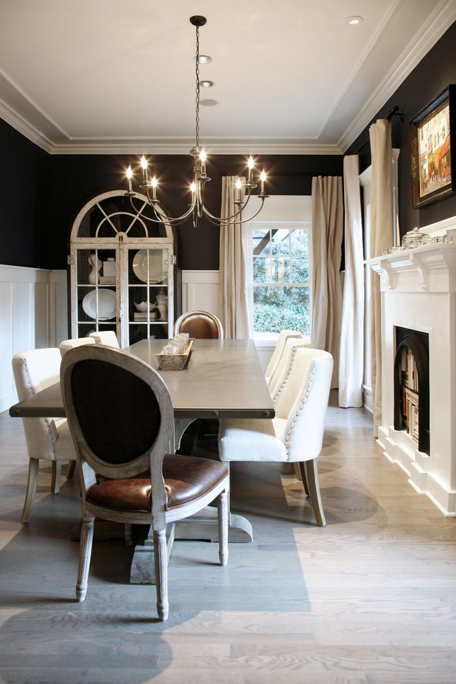 Inspiration for a large eclectic separate dining room in Atlanta with blue walls, medium hardwood floors, a standard fireplace and a wood fireplace surround.