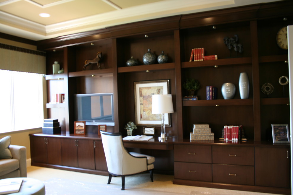 This is an example of a large traditional study room in Miami with beige walls and a built-in desk.