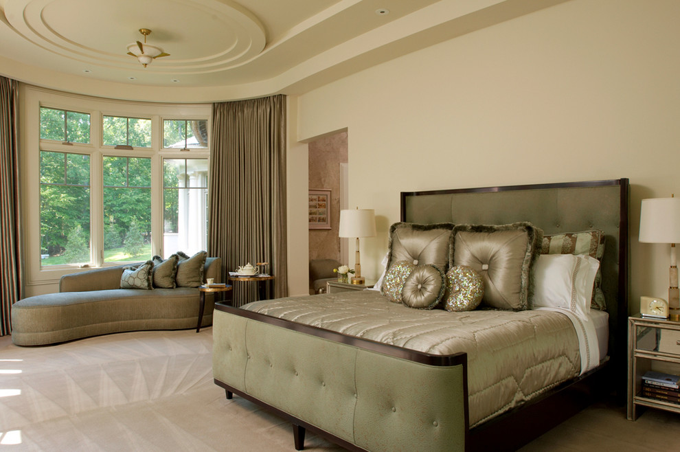 This is an example of an expansive traditional master bedroom in DC Metro with beige walls and carpet.