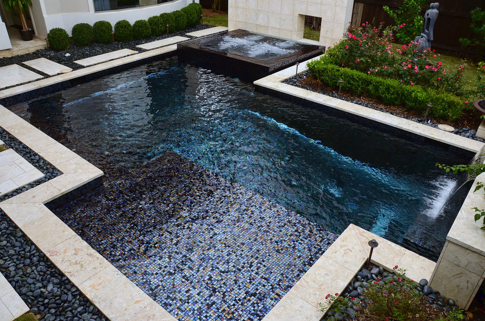 Large midcentury backyard custom-shaped pool in Houston with a hot tub and tile.