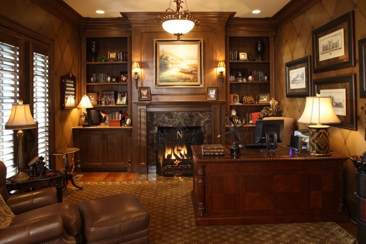 Photo of a large arts and crafts study room in Other with brown walls, medium hardwood floors, a standard fireplace, a freestanding desk and a stone fireplace surround.