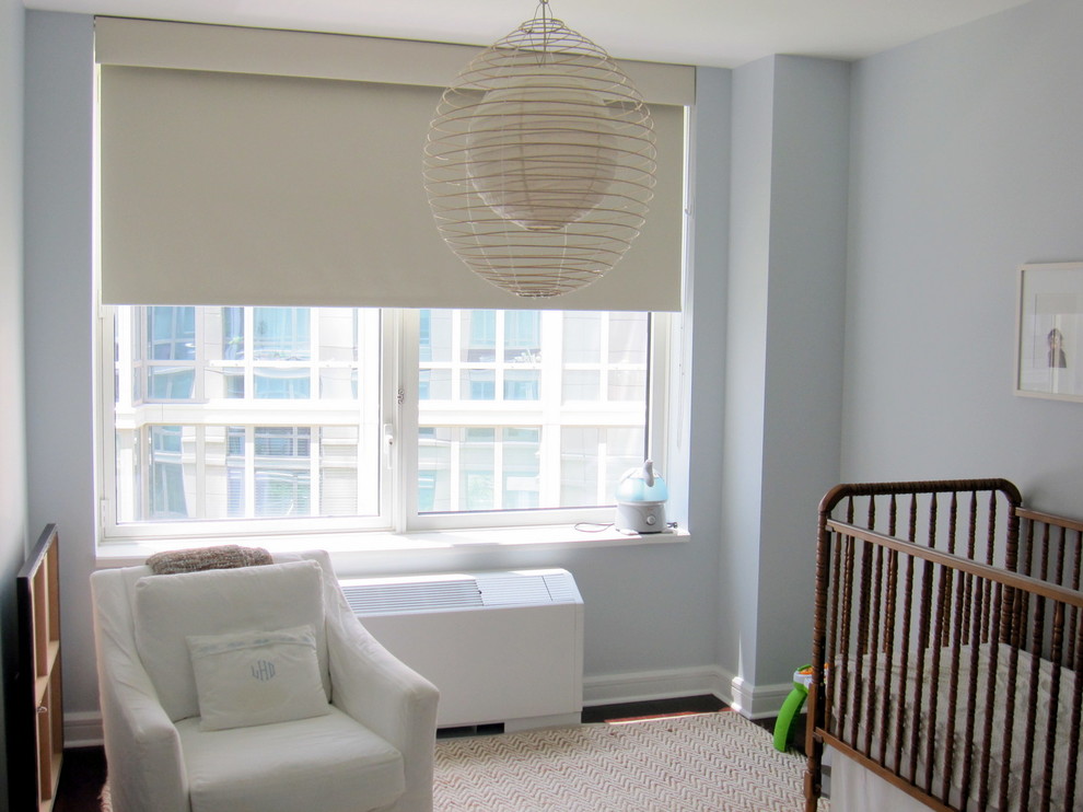 Design ideas for a mid-sized contemporary gender-neutral nursery in New York with blue walls, dark hardwood floors and brown floor.
