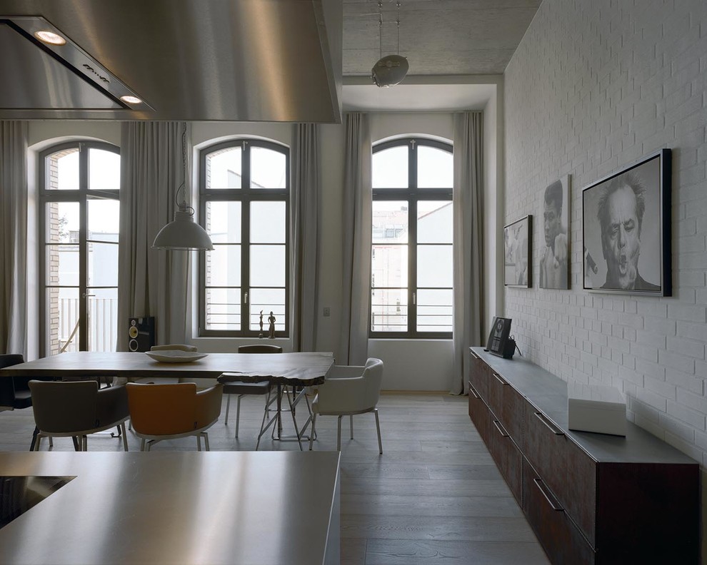 Photo of an expansive contemporary open plan dining in Berlin with white walls and no fireplace.