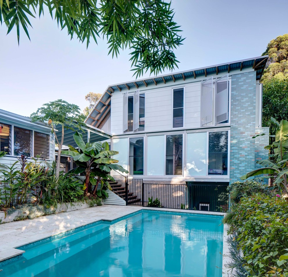 Photo of a tropical courtyard rectangular lap pool in Sydney.