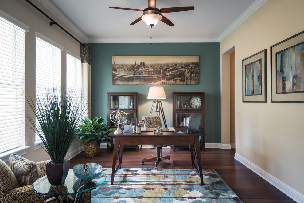 Mid-sized transitional freestanding desk dark wood floor study room photo in Orlando with no fireplace and blue walls