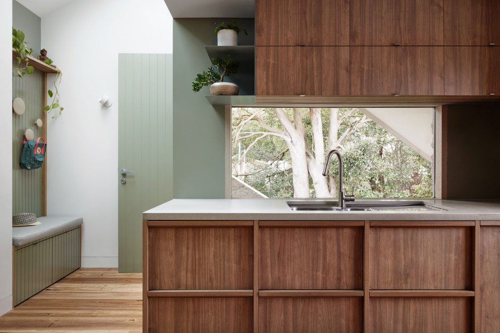 This is an example of a medium sized nautical galley kitchen pantry in Melbourne with a submerged sink, medium wood cabinets, quartz worktops, green splashback, porcelain splashback, medium hardwood flooring, no island and grey worktops.