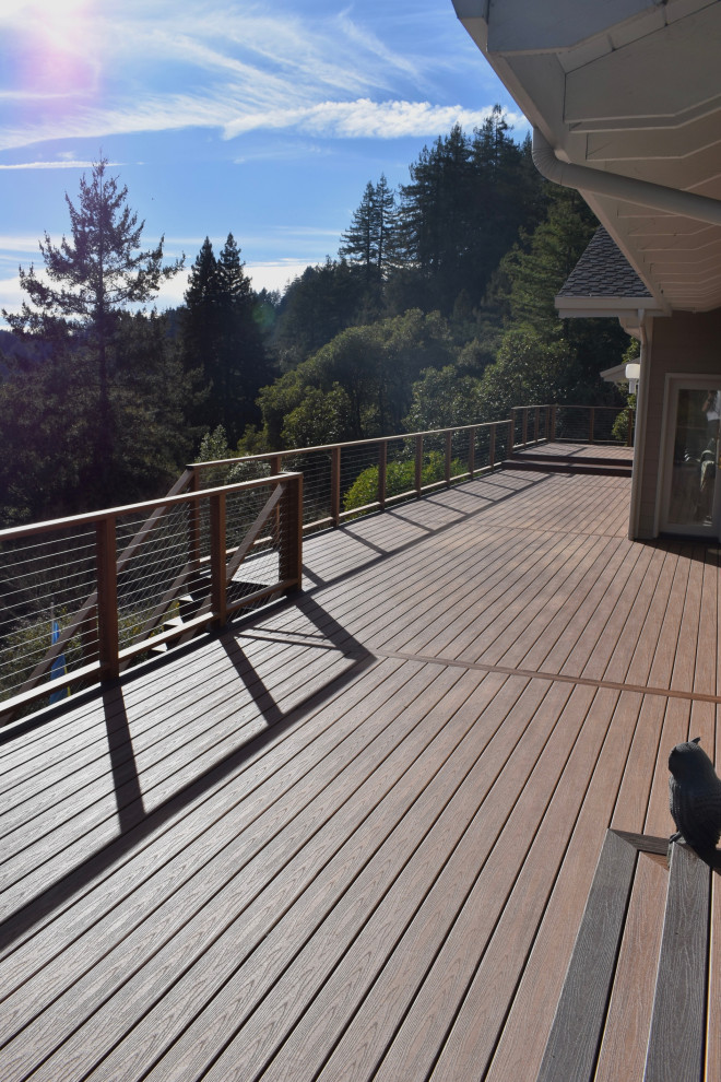 Minimalist backyard second story cable railing deck photo