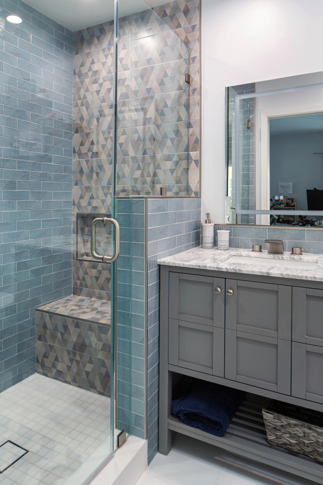 Photo of a small midcentury kids bathroom in Los Angeles with shaker cabinets, grey cabinets, an alcove shower, a two-piece toilet, blue tile, ceramic tile, white walls, marble floors, an undermount sink, marble benchtops, white floor, a hinged shower door, white benchtops, a niche, a single vanity and a freestanding vanity.