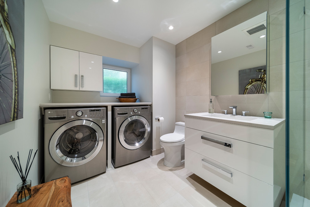 Design ideas for a small modern 3/4 bathroom in Vancouver with flat-panel cabinets, white cabinets, a corner shower, a one-piece toilet, beige tile, stone tile, white walls, ceramic floors, an undermount sink, quartzite benchtops, white floor, a hinged shower door and white benchtops.