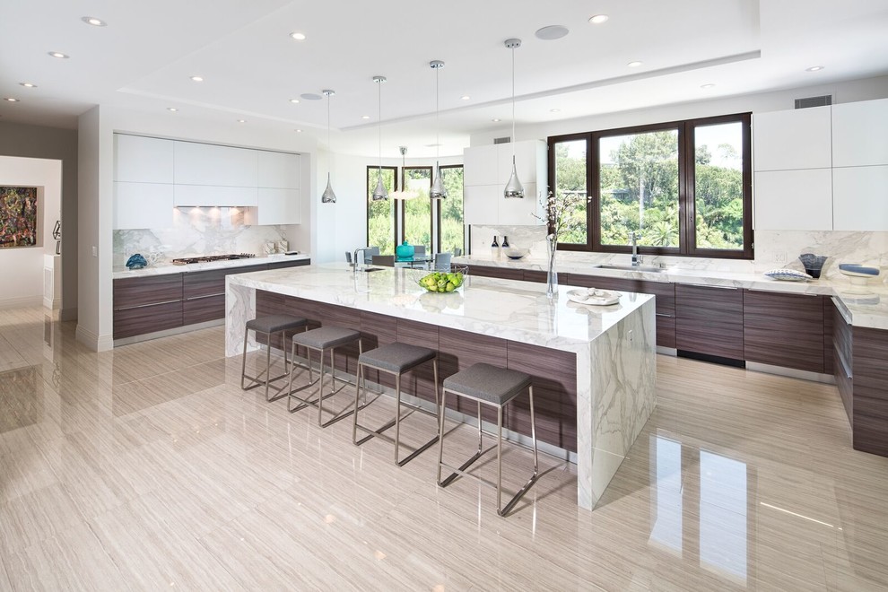 Photo of a large contemporary l-shaped eat-in kitchen in Los Angeles with flat-panel cabinets, white cabinets, marble benchtops, multi-coloured splashback, stone slab splashback, panelled appliances, with island, an undermount sink and porcelain floors.
