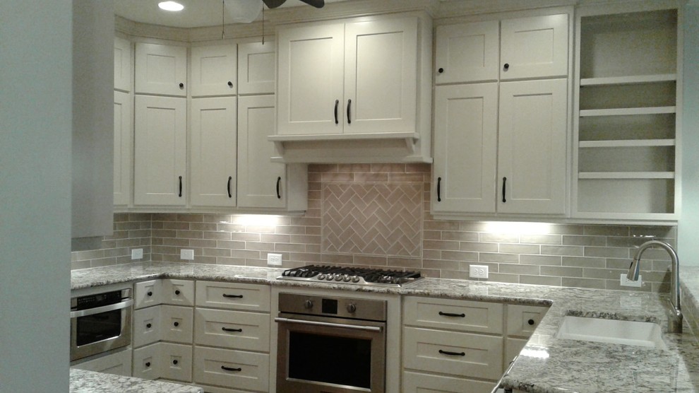 Kitchen - light wood floor kitchen idea in Raleigh with an undermount sink, shaker cabinets, granite countertops, porcelain backsplash and stainless steel appliances