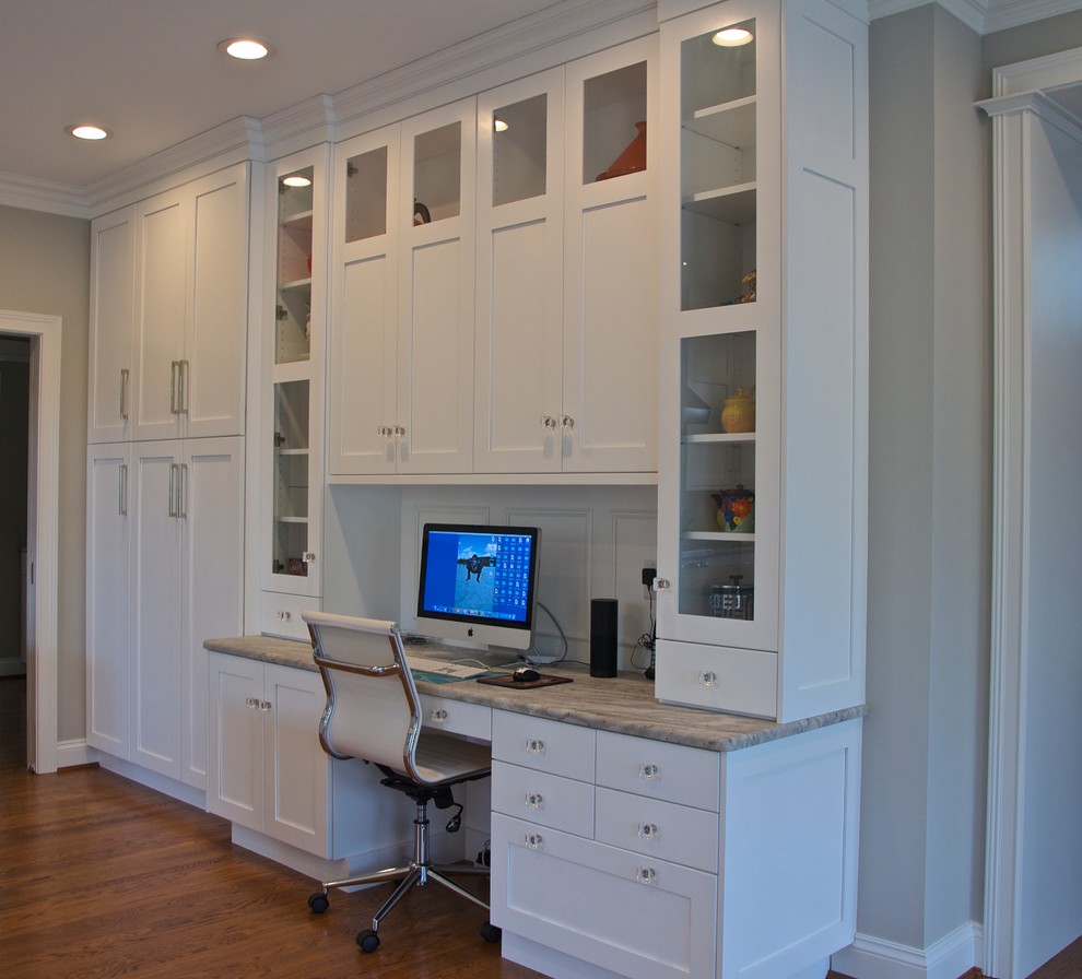 Inspiration for a large transitional l-shaped medium tone wood floor and brown floor eat-in kitchen remodel in Cincinnati with an undermount sink, shaker cabinets, white cabinets, granite countertops, white backsplash, ceramic backsplash, paneled appliances and an island