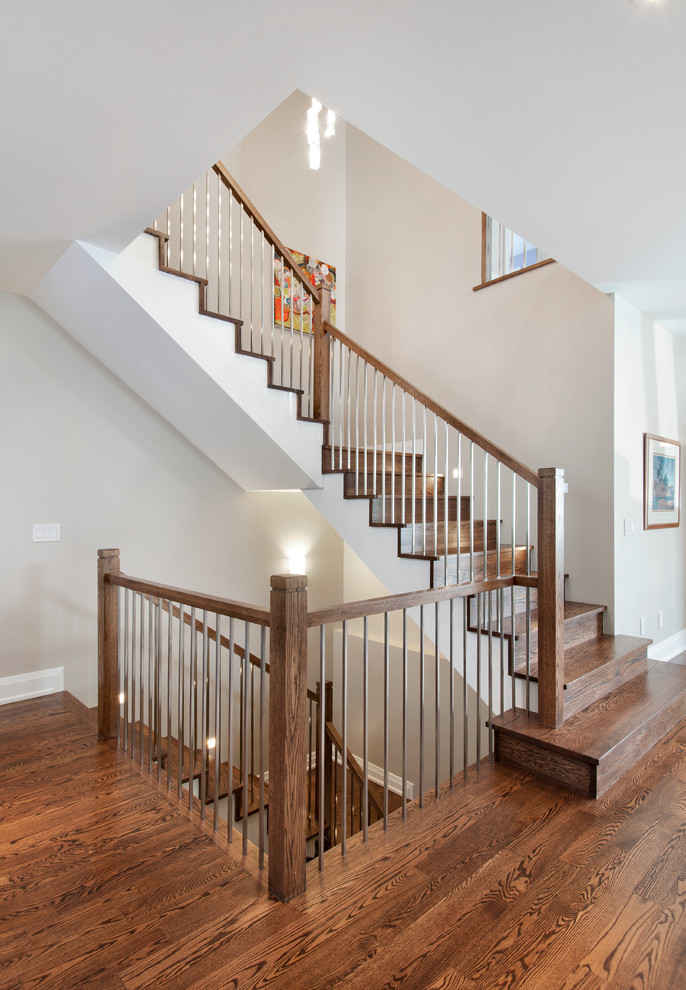 This is an example of a transitional wood l-shaped staircase in Ottawa with wood risers.