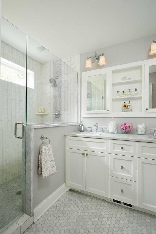 Inspiration for a mid-sized transitional master bathroom in Minneapolis with an undermount sink, shaker cabinets, white cabinets, stone tile, grey walls, mosaic tile floors, marble benchtops, white tile and an alcove shower.