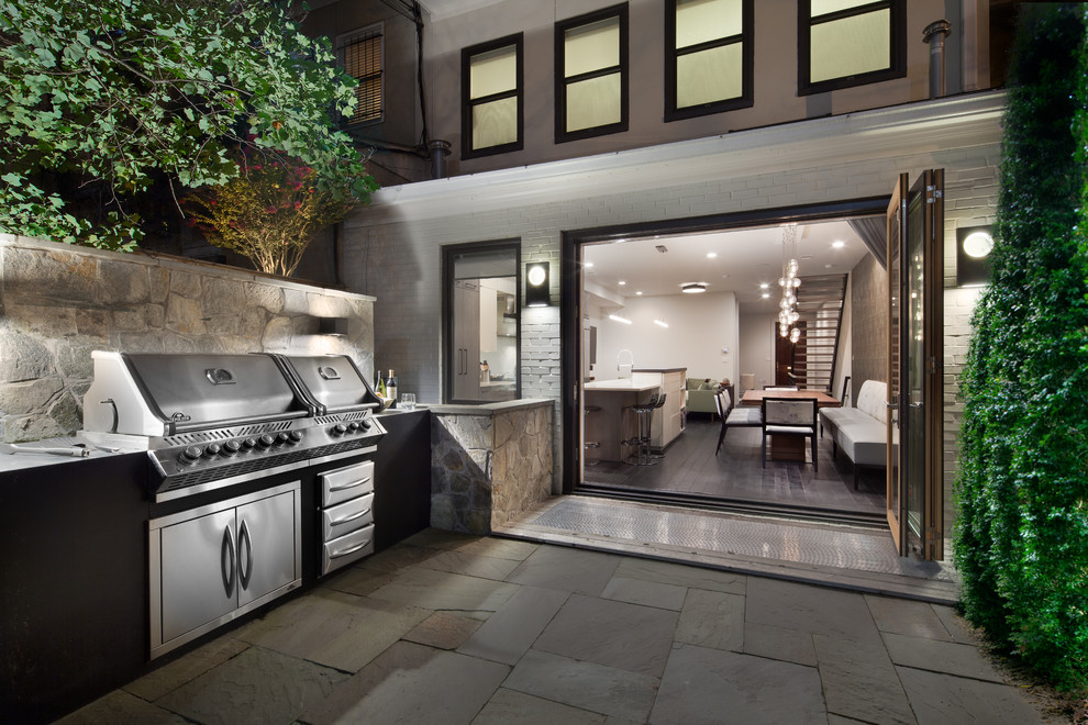 Photo of a contemporary backyard patio in DC Metro with an outdoor kitchen, natural stone pavers and no cover.