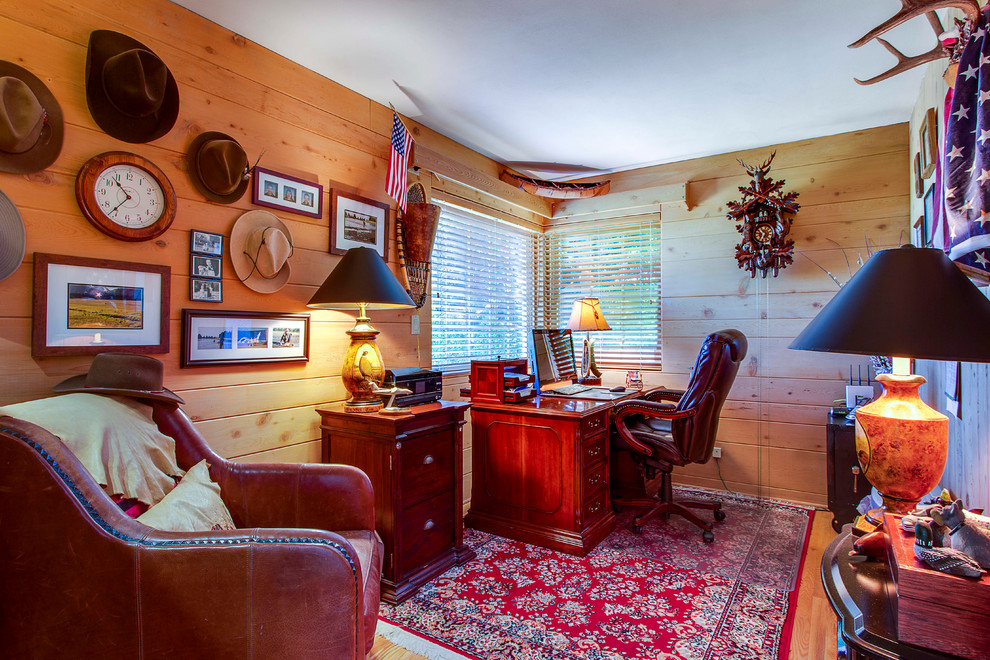 Mid-sized country study room in Seattle with brown walls, light hardwood floors, no fireplace and a freestanding desk.