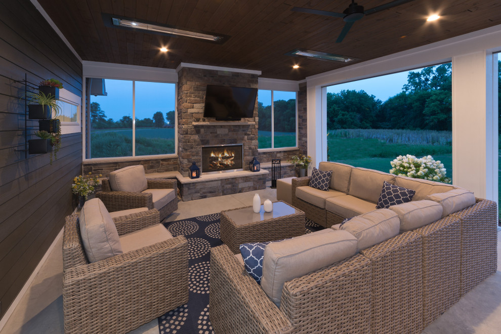 Design ideas for a transitional backyard patio in Other with with fireplace and a roof extension.