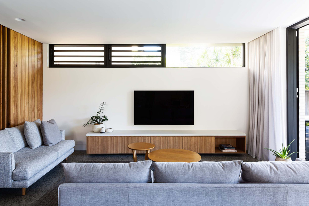 Inspiration for a contemporary living room in Sydney with white walls, carpet, a wall-mounted tv and grey floor.