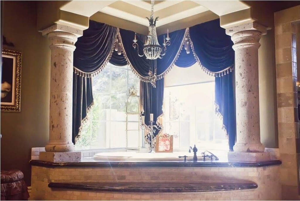 Large transitional master beige tile and stone tile drop-in bathtub photo in Phoenix with brown walls