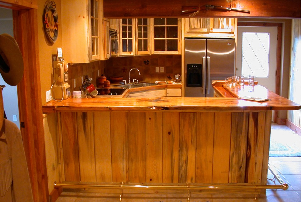 Example of a mid-sized mountain style l-shaped ceramic tile eat-in kitchen design in Phoenix with a double-bowl sink, shaker cabinets, light wood cabinets, wood countertops, brown backsplash, ceramic backsplash, stainless steel appliances and a peninsula