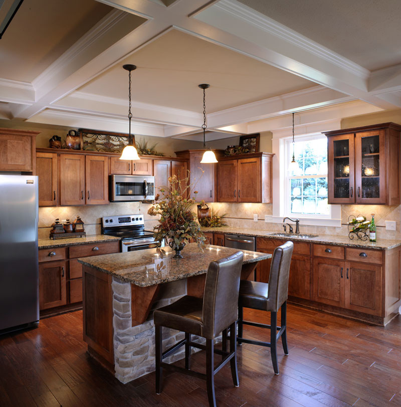 Design ideas for a country l-shaped eat-in kitchen with an undermount sink, shaker cabinets, medium wood cabinets, beige splashback, stainless steel appliances, medium hardwood floors, with island, beige floor and coffered.