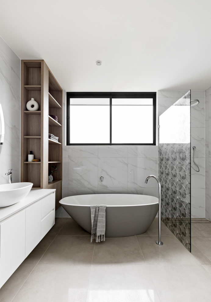 Photo of a large contemporary master bathroom in Sydney with flat-panel cabinets, white cabinets, a freestanding tub, a curbless shower, white tile, a vessel sink, grey floor, an open shower, white benchtops and a floating vanity.