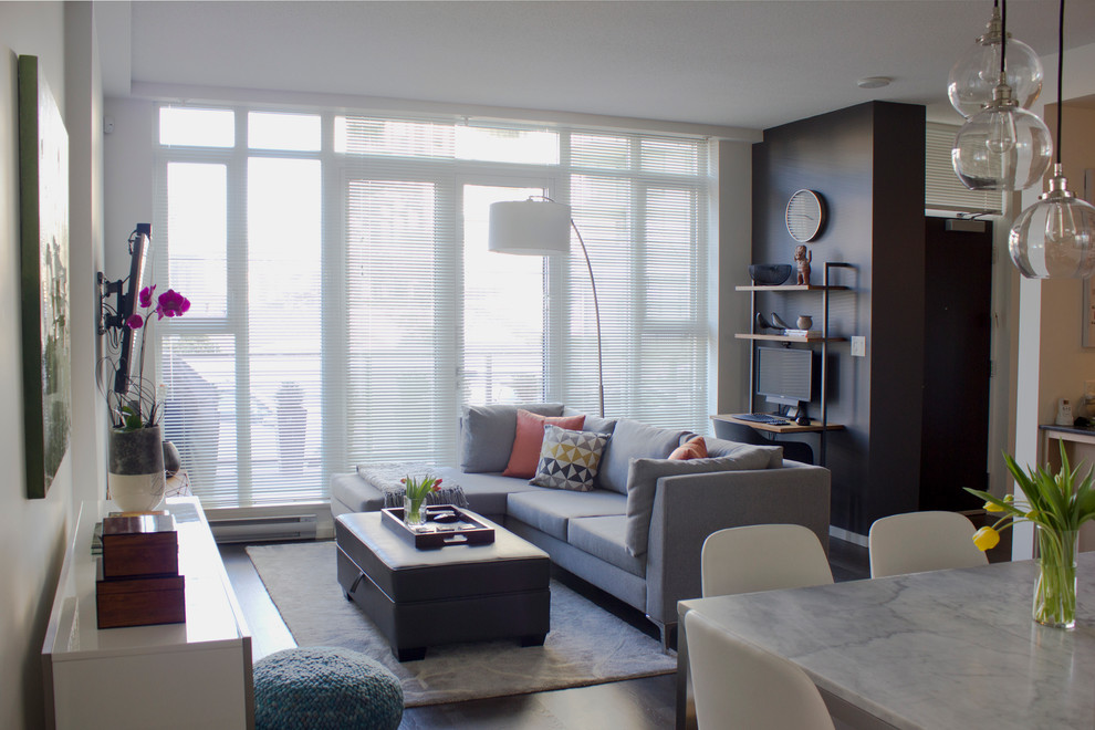 Small minimalist open concept dark wood floor living room photo in Vancouver with white walls and a wall-mounted tv