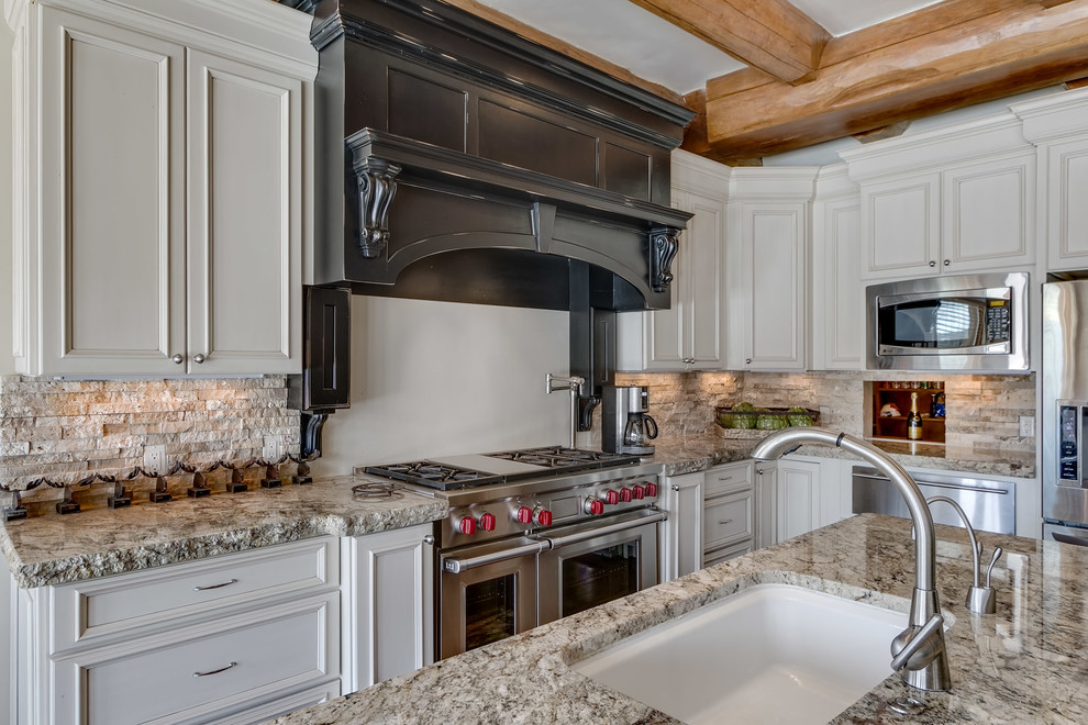 Inspiration for a mid-sized rustic l-shaped medium tone wood floor and brown floor eat-in kitchen remodel with an undermount sink, beaded inset cabinets, white cabinets, granite countertops, beige backsplash, stone tile backsplash, stainless steel appliances and an island