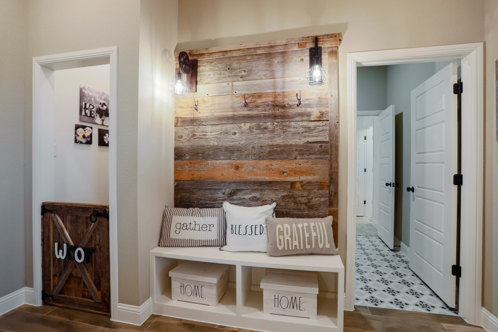 This is an example of a farmhouse boot room in Dallas with beige walls, dark hardwood flooring and tongue and groove walls.