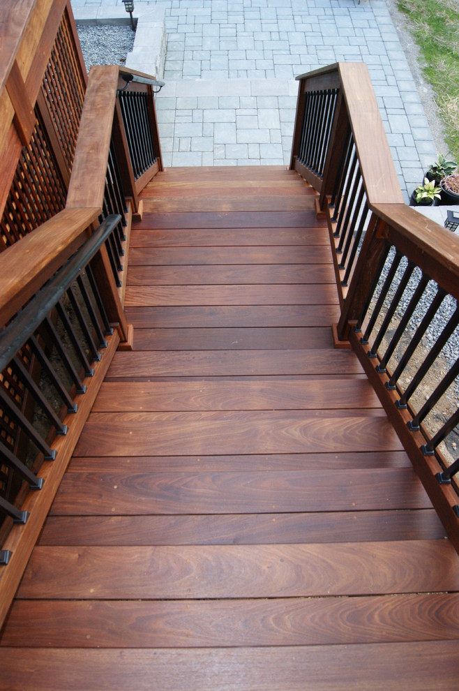 This is an example of a mid-sized traditional wood straight staircase in New York with wood risers.